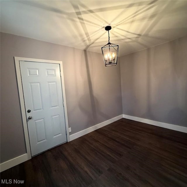 163 The Brooklands, Akron, OH 44305 - unfurnished room with baseboards, dark wood-style floors, and a chandelier