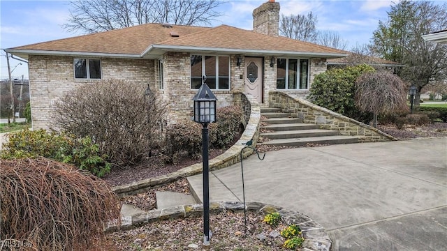8187 N Lima Rd, Poland, OH 44514 - view of front of property featuring a chimney, a shingled roof, and brick siding