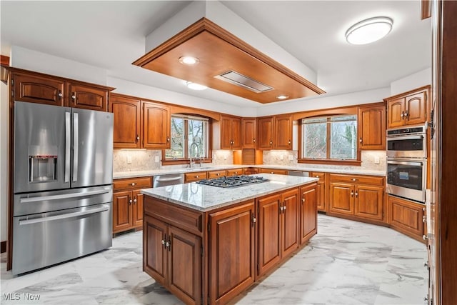 8187 N Lima Rd, Poland, OH 44514 - kitchen featuring appliances with stainless steel finishes, light marble finish floors, a sink, and healthy amount of natural light