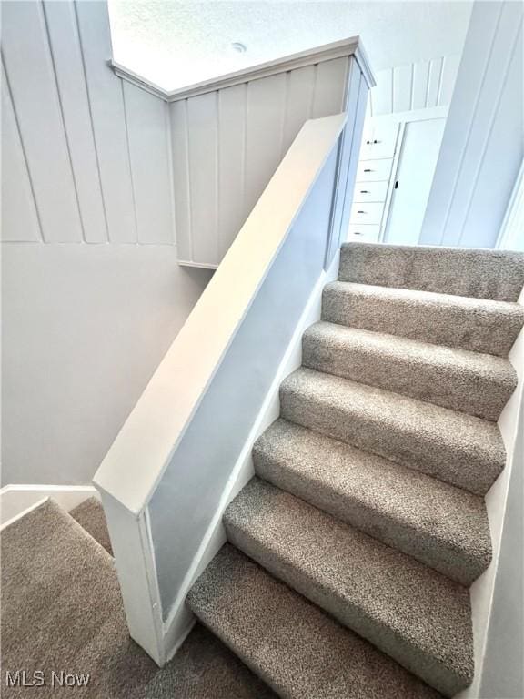 stairway featuring carpet floors