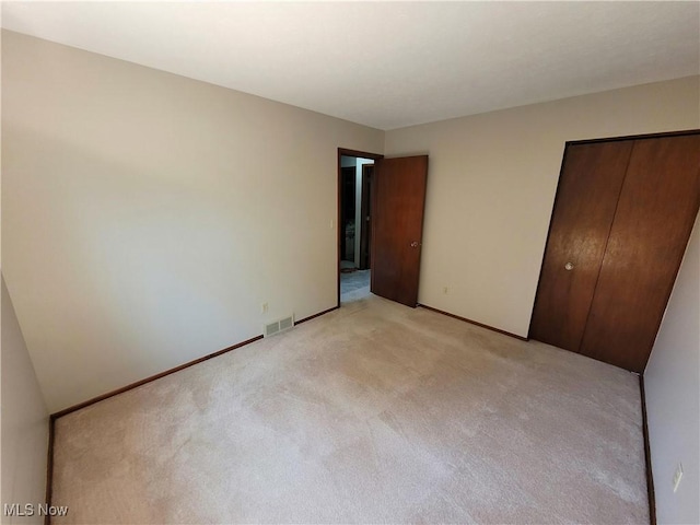 10360 Rischel Rd, Wadsworth, OH 44281 - unfurnished bedroom featuring baseboards, visible vents, a closet, and light colored carpet