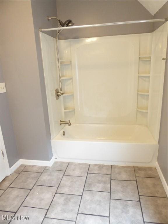 bathroom with  shower combination, baseboards, and tile patterned floors
