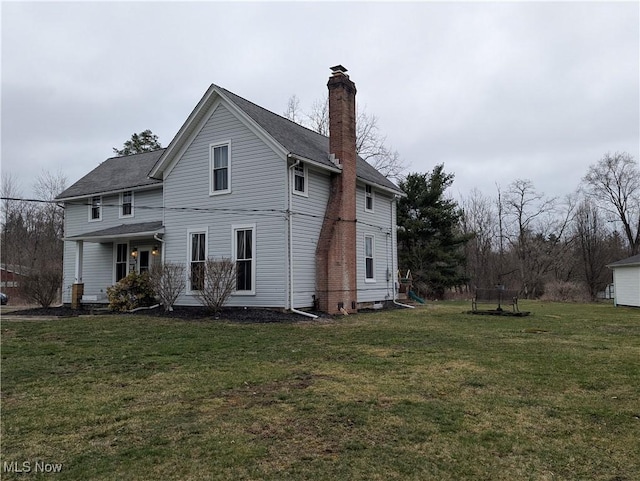 11154 Edgerton Rd, North Royalton, OH 44133 - rear view of house with a chimney and a lawn