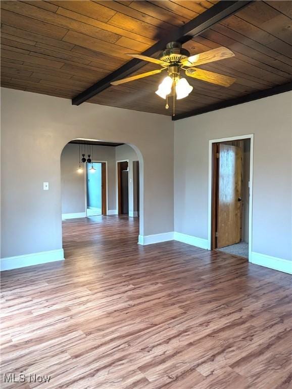11154 Edgerton Rd, North Royalton, OH 44133 - unfurnished room with arched walkways, a wood ceiling with exposed beams, wood finished floors, and ceiling fan