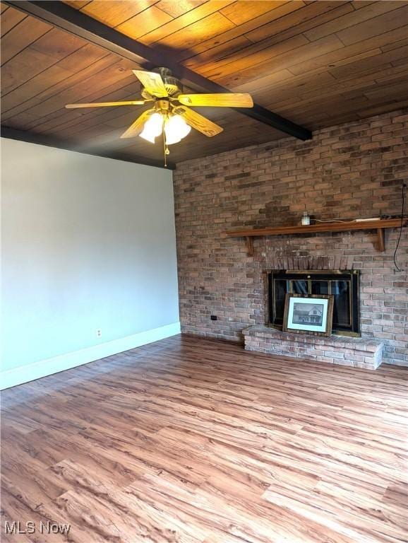 11154 Edgerton Rd, North Royalton, OH 44133 - unfurnished living room with a wooden ceiling with exposed beams, wood finished floors, ceiling fan, and a brick fireplace