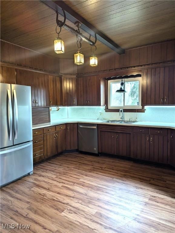 11154 Edgerton Rd, North Royalton, OH 44133 - kitchen with appliances with stainless steel finishes, wood finished floors, light countertops, a wood ceiling with exposed beams, and dark brown cabinetry