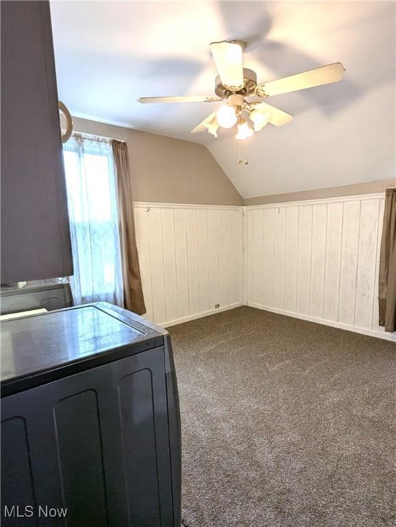 11154 Edgerton Rd, North Royalton, OH 44133 - bonus room featuring ceiling fan, washer / clothes dryer, vaulted ceiling, dark carpet, and wainscoting