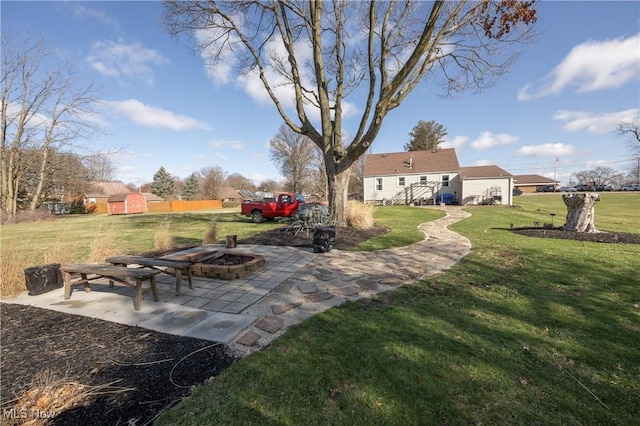 view of yard with a fire pit and a patio area