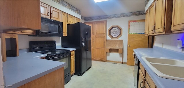712 Circle Dr, Belpre, OH 45714 - kitchen with light countertops, a sink, black appliances, and light floors