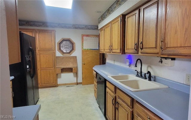 712 Circle Dr, Belpre, OH 45714 - kitchen featuring a sink, black appliances, and brown cabinets