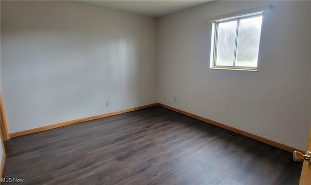 712 Circle Dr, Belpre, OH 45714 - spare room featuring dark wood-style floors, baseboards, and visible vents