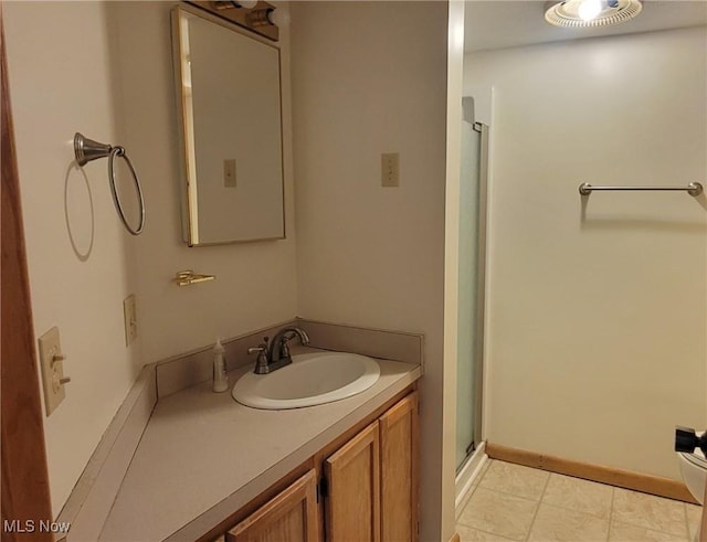 712 Circle Dr, Belpre, OH 45714 - bathroom featuring a stall shower, baseboards, and vanity