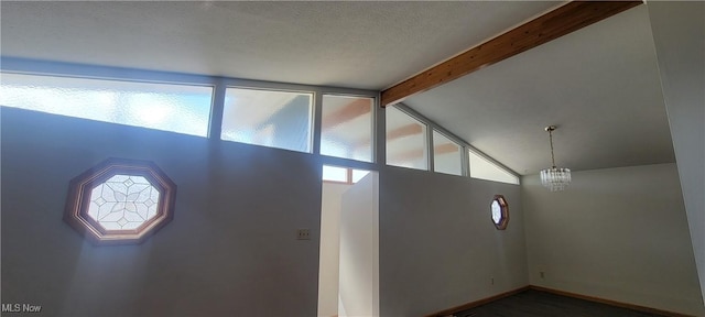 712 Circle Dr, Belpre, OH 45714 - entryway featuring vaulted ceiling with beams, a notable chandelier, baseboards, and a textured ceiling