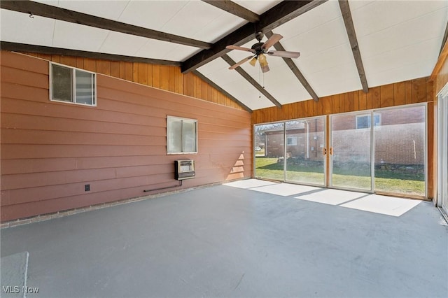 unfurnished sunroom featuring heating unit, beam ceiling, and ceiling fan
