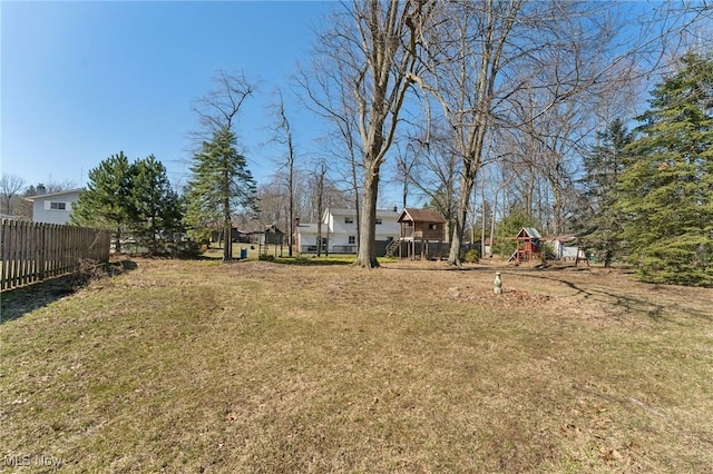 view of yard featuring fence and a playground