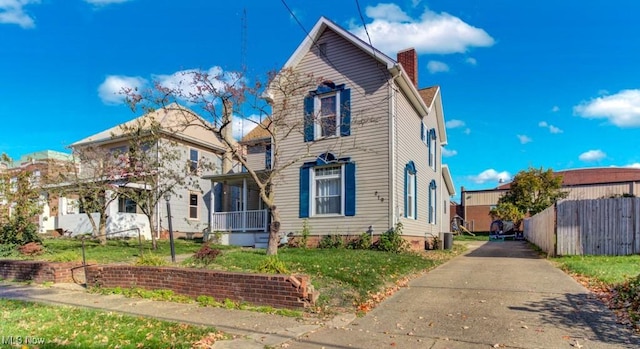 view of front facade with a front lawn and a chimney
