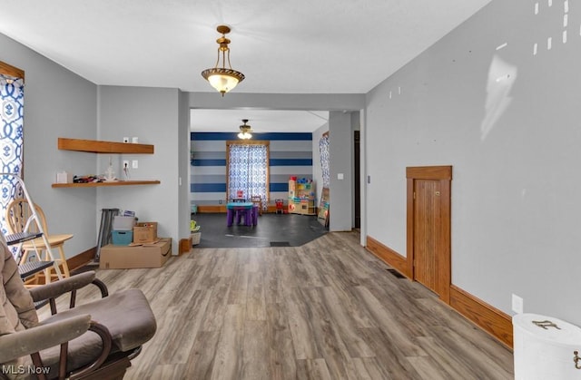 interior space with baseboards and wood finished floors