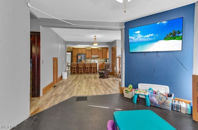game room with light wood-style floors and visible vents