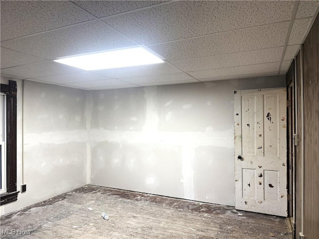 unfurnished room featuring a drop ceiling