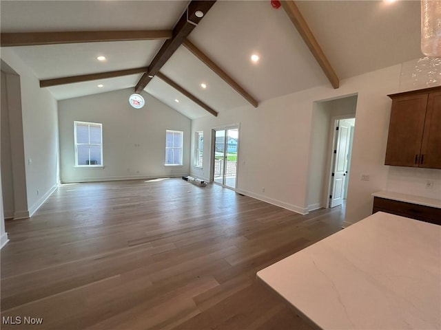 unfurnished living room with baseboards, lofted ceiling with beams, wood finished floors, and recessed lighting