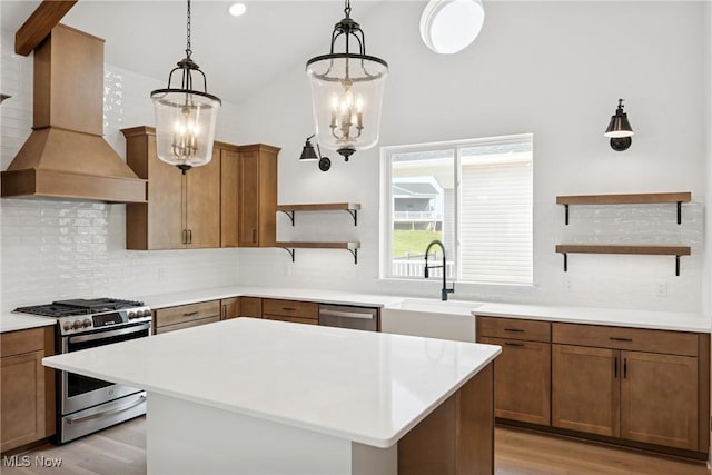 8933 Camden Rd NW, Massillon, OH 44646 - kitchen with open shelves, appliances with stainless steel finishes, custom exhaust hood, a chandelier, and tasteful backsplash