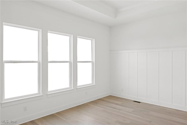 8933 Camden Rd NW, Massillon, OH 44646 - empty room with light wood finished floors and a wainscoted wall