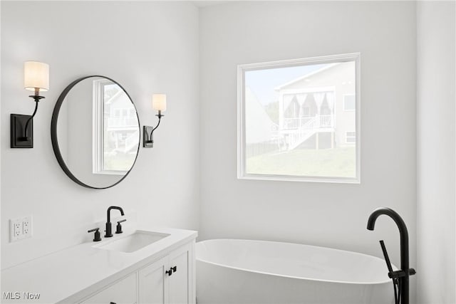 8933 Camden Rd NW, Massillon, OH 44646 - full bathroom featuring vanity and a freestanding tub