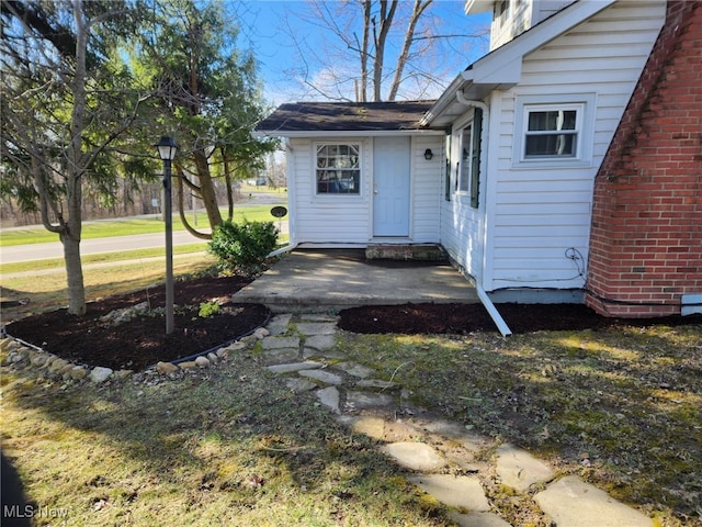 doorway to property featuring brick siding