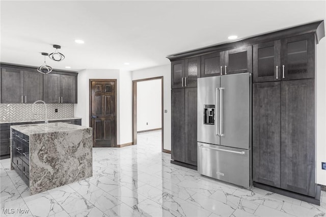 3189 Chardonnay Ln, Poland, OH 44514 - kitchen with decorative backsplash, light stone counters, marble finish floor, and high end fridge