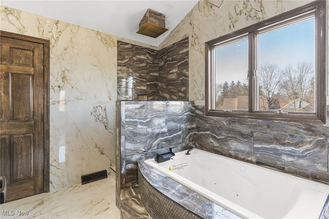 3189 Chardonnay Ln, Poland, OH 44514 - bathroom with tile walls, stone wall, marble finish floor, and a tub with jets