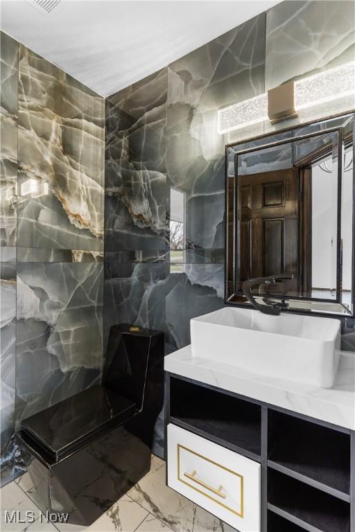 3189 Chardonnay Ln, Poland, OH 44514 - full bathroom featuring tile walls, marble finish floor, vanity, and walk in shower