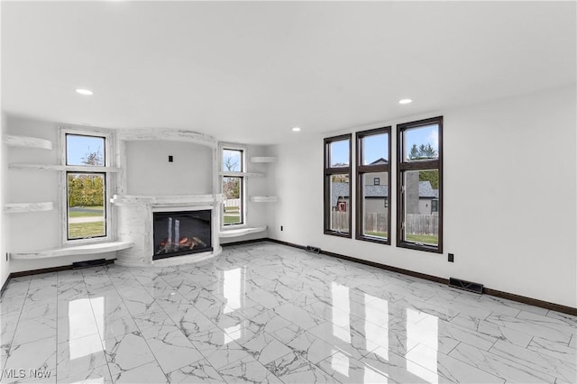 3189 Chardonnay Ln, Poland, OH 44514 - unfurnished living room featuring visible vents, baseboards, recessed lighting, marble finish floor, and a glass covered fireplace