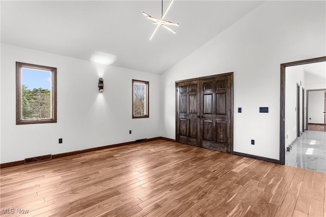 3189 Chardonnay Ln, Poland, OH 44514 - unfurnished bedroom featuring visible vents, high vaulted ceiling, and wood finished floors