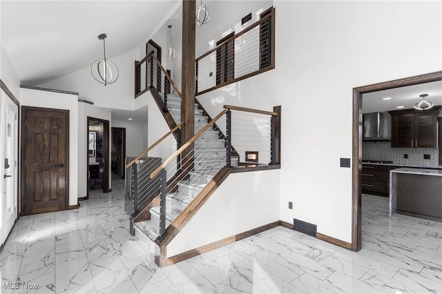 3189 Chardonnay Ln, Poland, OH 44514 - foyer entrance featuring high vaulted ceiling, marble finish floor, baseboards, and stairs