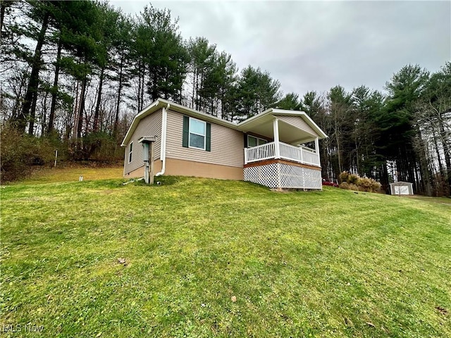 back of house featuring a storage unit, an outdoor structure, and a yard