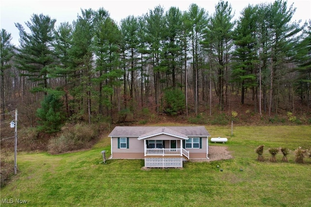 exterior space featuring a wooded view