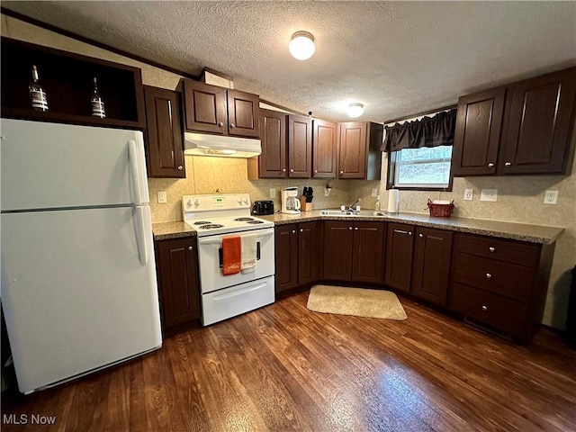 kitchen featuring a sink, dark wood-style flooring, under cabinet range hood, white appliances, and dark brown cabinets