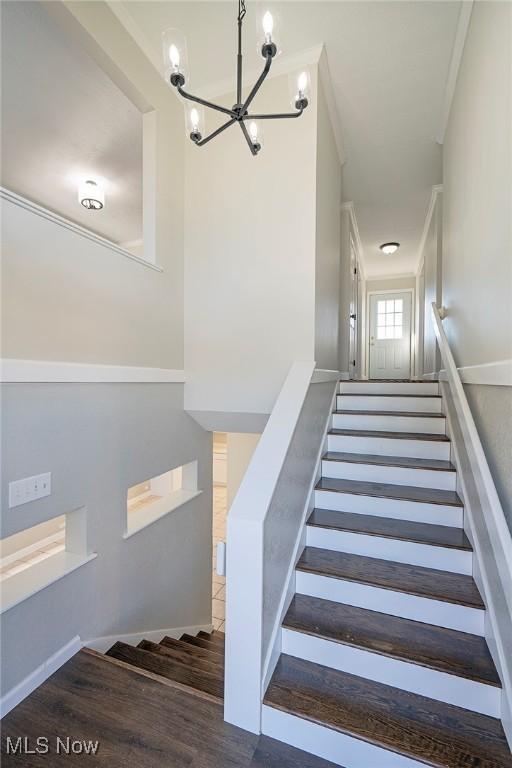 507 Stone Rd, Belpre, OH 45714 - stairs with a notable chandelier and wood finished floors