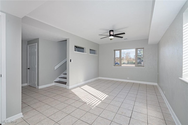 507 Stone Rd, Belpre, OH 45714 - spare room featuring baseboards, ceiling fan, stairway, and light tile patterned flooring