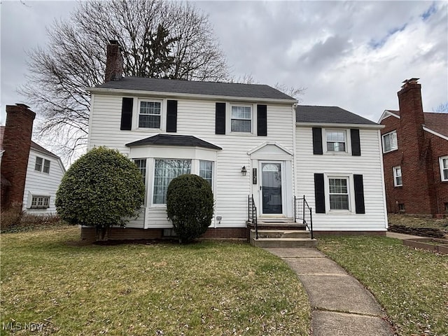 colonial-style house with a front yard