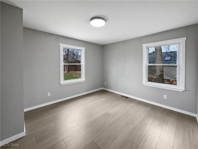 8414 York Rd, North Royalton, OH 44133 - unfurnished room featuring plenty of natural light, wood finished floors, and baseboards