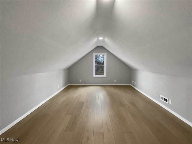 8414 York Rd, North Royalton, OH 44133 - bonus room featuring vaulted ceiling, wood finished floors, visible vents, and baseboards