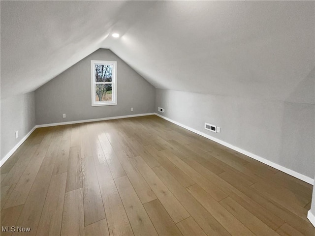 8414 York Rd, North Royalton, OH 44133 - bonus room with vaulted ceiling, visible vents, baseboards, and wood finished floors