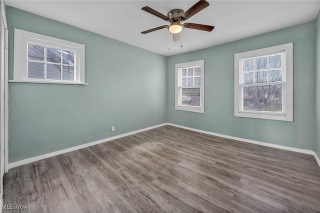 11504 E Blvd, Cleveland, OH 44105 - empty room featuring wood finished floors, baseboards, a wealth of natural light, and a ceiling fan