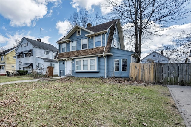11504 E Blvd, Cleveland, OH 44105 - view of front of home featuring a chimney, a shingled roof, fence, and a front lawn