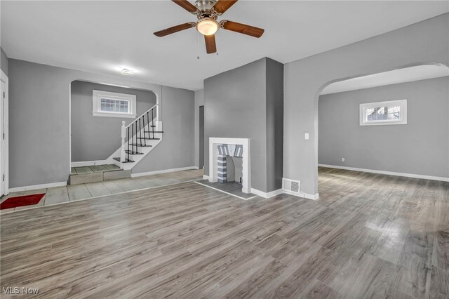 11504 E Blvd, Cleveland, OH 44105 - basement with visible vents, arched walkways, a ceiling fan, stairway, and wood finished floors