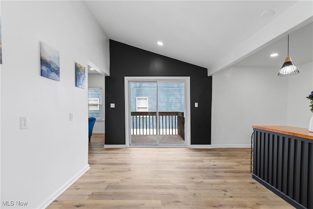 corridor featuring baseboards, lofted ceiling, recessed lighting, and light wood-style floors