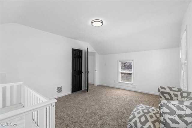 carpeted bedroom with baseboards, lofted ceiling, and visible vents