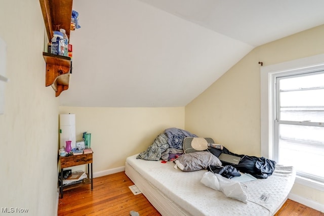 7115 Laverne Ave, Parma, OH 44129 - bedroom featuring baseboards, lofted ceiling, and light wood-style floors