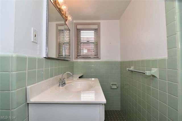 bathroom featuring vanity, tile walls, and wainscoting